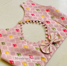 a baby bib with a bow on it