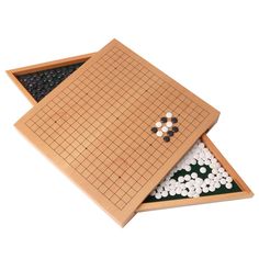 two wooden games boards with white and black pieces in the bottom one has a board game on it