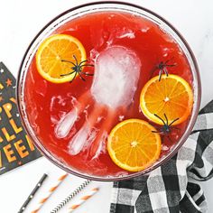 a drink with oranges and spider legs in it