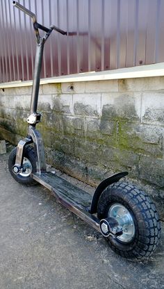 an old scooter is parked in front of a building