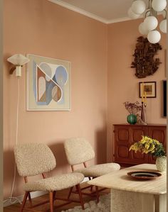 a living room with two chairs and a table