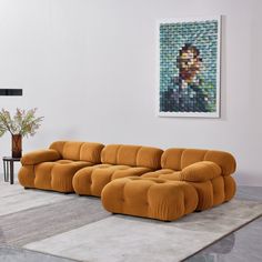 a living room scene with focus on the large couch and painting in the back ground