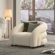 a white chair sitting in front of a window