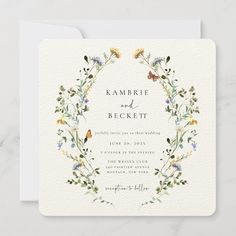 a wedding card with flowers and butterflies in the center, on a marble surface background