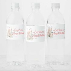 three plastic bottles with labels on them sitting on a marble countertop in front of a white background