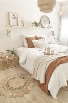 a bedroom with white walls and wooden flooring is decorated in neutral tones, such as beige