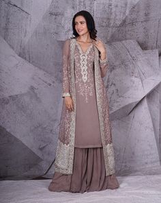 Enveloped between the earth hues of grey and shimmering floral silver embroidery work lies this beautiful set. The jacket is embroidered with floral embroidery done with kasab thread and highlighted with sequins, stones and kardana beads. The kurta neckline is embellished with coordinated embroidery and the outfit is paired with georgette palazzo pants. Colour : Grey Fabric : Georgette palazzo and kurti, net jacket Embroidery : 3D floral embroidery done with kasab thread and highlighted with sto Palazzo And Kurti, Silver Embroidery Work, Kurta Neckline, Indian Bridal Couture, Indian Wedding Bride, Bridal Lengha, Indian Bridal Lehenga, Silver Embroidery, Grey Jacket