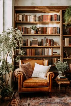 a brown leather chair sitting in front of a book shelf filled with books