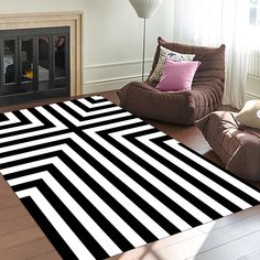 a black and white rug in the middle of a living room with two brown chairs