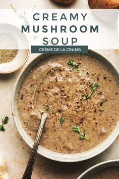 creamy mushroom soup in a white bowl with a spoon