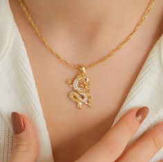 24K Gold Plated Zircon Stone Dragon Necklace, Dragon Pendant, Charm Necklace, Unisex Necklace, Birthday Gift, Cubic Zirconia Necklace, Gift ♡ Comes to you in an elegant and pretty box. Ready to give as a gift ♡ The pendants is gold plated brass. ♡ The chain length of the product is 16 inches/40 cm - 1.9 inch/5 cm extension chain ♡ To prevent the color of your jewelry from fading; Care should be taken to avoid contact with external factors such as water, perfume, cream. ♡ Keeping your jewelry in a pouch or a box after using it will prolong the life of your jewelry. ♡ You can do your product maintenance with a cotton-soft dry cloth. ♡ Full address, contact person, and phone number are required for the shipping. ♡ The necklace will be specialized just for you. * MADE WITH LOVE * This necklace Dragon Jewelry Necklace, Dragon Locket, Perfume Cream, Stone Dragon, Necklace Dragon, Water Perfume, Zirconia Necklace, Gold Dragon, Dragon Necklace