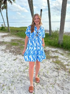 This will be a wear-on-repeat favorite, whether you dress it down with white sneakers or elevate the look with strappy heels. It makes a great piece to pack for your upcoming vacation! Details: Short dolman sleeves, button down front, babydoll design, side pockets, and an oversized fit. Size & Fit: This dress runs oversized. Elizabeth is pictured wearing the size small. Blue Dress For Summer Vacation Outings, Blue Cotton Dress For Summer Outings, Casual Vacation Dress For Daywear, Blue Relaxed Fit Dress For Day Out, Casual Vacation Daywear Dresses, Casual Daywear Dress For Vacation, Casual Dress For Vacation Daywear, Trendy Relaxed Fit Beach Dress, Blue Relaxed Fit Dress For Vacation