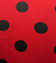 a red and black polka dot fabric with small black dots on the bottom half of it