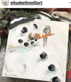 a snowman painting with two birds on it