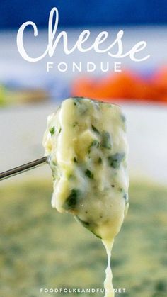 broccoli cheese fondue is being lifted from a spoon