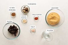 an assortment of spices and seasonings on a white table with words describing the ingredients