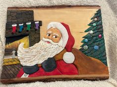 a painting of santa claus sitting in front of a fireplace