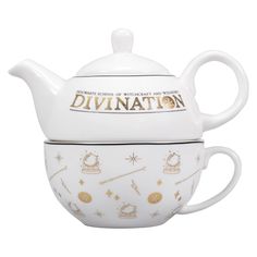 a white tea pot with gold writing on it and the words divintation written in gold