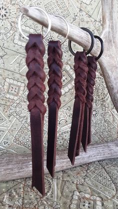 three leather tassels hanging from a hook