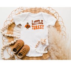 "Little Turkey Brown Onesie®, Natural Onesie®, Toddler Shirt, Cute Turkey Shirt, Little Turkey Kids, Thanksgiving Shirt, Little Turkey Shirt Premium Quality Printed in the USA. HOW TO ORDER T-SHIRT 1-) Please, Check and Review all Photos. 2-) Select Your T-shirt Color. 3-) Select Your T-shirt Size. 4-) Click ADD TO CART and You can go back to add more product color and text color or You can complete the checkout process. 5-)Please Click \"Proceed to Check Out\" 6-) Finally, Your Custom Shirt will be ready to ship 1-3 Business Day. Product Side seams, retail fit Shoulder to shoulder taping Unisex sizing Production and Shipping --Production: 1-3 days --Standard Shipping (2-3 business days after production time) It's a custom and unique gift for a sister, gift for a girl friend, gift for litt Halloween Baby Gift, Funny Baby Shower Gifts, Baby Halloween Outfits, Hipster Babies, Unicorn Halloween, Thanksgiving Baby, Thanksgiving Svg, Funny Baby Onesies, First Halloween