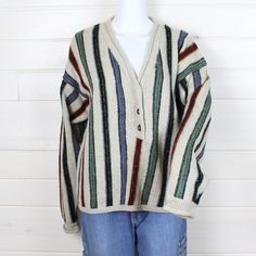 Good condition, vintage sweater. Ivy Wear brand. 70% acrylic, 30% wool. Made in China. Vintage tag size medium. V-neck henley. Boxy cut.  Colors are shades of red, blue, green, rust, and oatmeal beige.  Measurements:(inches) Chest: 47" Bottom Waistband: 42"  Sleeve: 29" (from bottom collar seam to cuff) Length:23 1/2" BEFORE YOU BUY, PLEASE USE THE LISTED MEASUREMENTS TO CHECK FOR FIT:  Pick a garment that fits you well ( similar to what you are ordering; pants, blouse, shoes, etc), and measure them, and compare with the garment you are buying to get an idea of how it will fit you.  For more information on how we measure our garments, please refer to the Sizing Jeans and Sizing Details FAQS.  PLEASE REVIEW SHOP POLICIES BEFORE ORDERING. Knit V Neck Sweater, Ankle Sleeve, Knit V Neck, Boxy Sweater, Vintage Sweater, Red Blue Green, Wool Blend Sweater, Shades Of Red, Vintage Sweaters