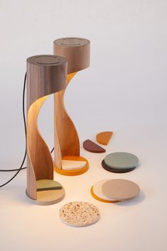 a wooden table lamp with different shapes and colors on the top, along with other wood objects