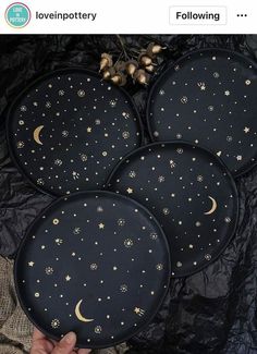 three black plates with gold stars and moon designs on them