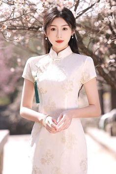 Exude elegance and grace in this feminine white cheongsam dress. Thanks to its versatile style, you can easily wear this cheongsam from day to night. This long cheongsam dress is designed in a timeless white color. This bright shade charmingly enhances the appearance of the Chinese dress. Elegant White Cheongsam For Spring, Spring Elegant Cheongsam With Stand Collar, Elegant Spring Cheongsam With Stand Collar, White Fitted Cheongsam With Stand Collar, Elegant Long Cheongsam For Summer, White Fitted Cheongsam For Party, Elegant White Ao Dai For Formal Occasions, Elegant Long Summer Cheongsam, White Summer Cheongsam With Stand Collar