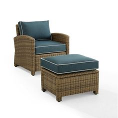 an outdoor chair and ottoman with blue cushions