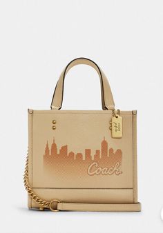 Coach X Jennifer Lopez Dempsey Tote 22 with NYC Skyline in Gold/Cream NWT C6494. New With tag 100 % authentic Price is firm COLOR: Gold/Cream Refined pebble leather Inside zip and multifunction pockets Snap closure, fabric lining Handles with 4 1/4" drop Detachable strap with 22 1/2" drop for shoulder or crossbody wear Four protective feet at base 8 3/4" (L) x 7 3/4" (H) x 4 1/4" (W) Coach x Jennifer Lopez A very special collection designed in collaboration with the one-and-only Jennifer Lopez S Coach Zip Top Tote, City Tote Bag, Bucket Tote Bag, Suede Tote Bag, Coach Tote Bags, Nyc Skyline, Grey Tote, Suede Tote, Bags Coach