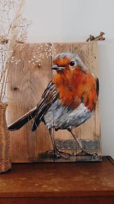 a painting of a bird sitting on top of a wooden shelf