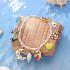 Capture the essence of summer with this unique Evil Eye Colorful Beaded Bracelet! Featuring a combination of multi-colored elements and a shining evil-eye, it is perfect for those who believe in the power of good luck. Adorable and pastel, this bracelet is a must-have for warding off misfortune and bringing a touch of the sea to your style. DETAILS Plating: 18K Gold Materials: 18K Gold on Brass, Natural Stones, Glass Beads Measurements: Length: 7.48"(19cm) + Extender: 1.96"(5cm) Weight: 15g Spiritual Crystal Bracelet With Colorful Beads For Festivals, Bohemian Beaded Charm Bracelet For Beach, Bohemian Charm Bracelet With Round Beads For Beach, Bohemian Charm Bracelets For Festivals, Bohemian Charm Bracelets For The Beach, Bohemian Beach Bracelets With Charms, Bohemian Multicolor Charm Bracelet For Beach, Multicolor Bohemian Evil Eye Bracelet For Festivals, Bohemian Multicolor Evil Eye Bracelet For Festivals