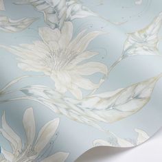 a blue and white floral wallpaper with large flowers on the back half of it