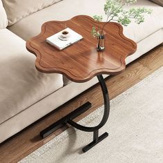 a wooden table sitting on top of a white rug in front of a beige couch