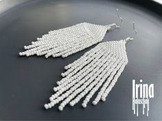 Beautiful beaded modern white earrings with fringe. Very lightweight. Measurements: Length - 2,8 inches (7 cm) Width - 1 inch (2,5 сm) Materials: medical steel, hypoallergenic hooks Czech glass beads Nylon Thread Patience and Creativity .. ready to be given away ! Contact me if you have any questions. I will be happy to answer :) More necklaces from glass or stones: https://www.etsy.com/shop/IrinaHaluschak?ref=seller-platform-mcnav§ion_id=17111035 Beaded earrings: https://www.etsy.com/shop/Irina White Beaded Earrings, Handmade Earrings Beaded, Bead Work Jewelry, White Earrings, Seed Bead Earrings, Multi Strand Necklace, Modern Earrings, Earrings Boho, Fringe Earrings