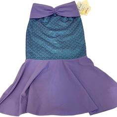 This Adorable Lavender & Teal Scale Print Fold-Over Mermaid Tail Skirt Is The Perfect Children's Swimwear, As It Is Sized Specifically For Kids And Will Grow With Your Child For Years To Come! The Mermaid Tail Lycra Fabric Provides Spf 50+ Protection And Is Made For Summer Water Activities. The Bright & Shiny Foil Printed Skirt Is Easy To Slide Over A Bathing Suit When On The Go With The Fold-Over Elastic Waistband. The Lycra Covered Stretch Waistband Makes The Skirt Expandable, To Make His/Her Summer Beach Mermaid Dress, Purple Sleeveless Mermaid Dress For Summer, Blue Fitted Mermaid Skirt, Fitted Purple Swim Skirt For Summer, Fitted Purple Skirt For Vacation, Purple Mermaid Dress For Summer, Summer Purple Mermaid Dress With Mermaid Hem, Purple Summer Mermaid Dress, Summer Purple Mermaid Dress