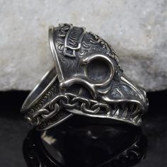 Elevate your style with our massive Morior Invictus Deacon Mongrels skull ring. Handcrafted in sterling silver, it embodies gothic and biker aesthetics, making a bold statement for those with a rebellious spirit. This unique piece is a testament to macabre elegance and a symbol of individuality. Whether you're a motorcycle enthusiast or simply appreciate the dark side of style, this ring is the perfect accessory to express your unique identity. Biker Skull Jewelry For Gift, Biker Style Skull Jewelry Gift, Biker Style Skull Jewelry For Gift, Biker Jewelry For Halloween Gift, Biker Style Jewelry For Halloween Gift, Biker Style Halloween Jewelry Gift, Adjustable Gothic Skull Ring Collectible, Collectible Punk Skull Jewelry, Handmade Metal Skull Ring Collectible