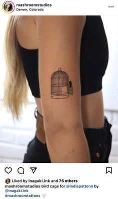 a woman with a birdcage tattoo on her arm