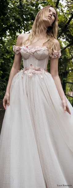 a woman wearing a dress with flowers on it