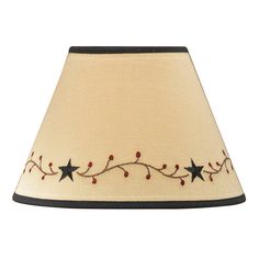 a lamp shade with stars and berries embroidered on the bottom, along with black trim