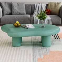 a living room with a gray couch and green coffee table