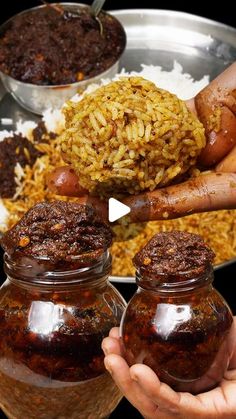 hands holding jars filled with food on top of a table