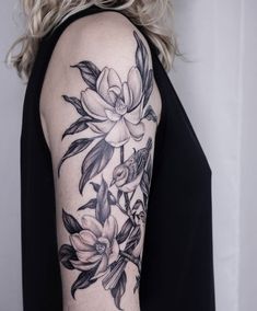 a woman with a black and white flower tattoo on her arm