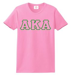 a pink t - shirt with the word aka printed in green letters on it