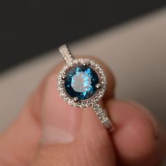 This is a gorgeous handmade creation. Its beauty is its simplicity & Elegance. The 7*7mm round cut London blue topaz is crafted in solid sterling silver and with rhodium plated. All item is sent in a beautiful gift box You can realize more lovely stuff clicking the link https://www.etsy.com/shop/knightjewelry?refshopsection_shophome_leftnav Please leave the correct address and you phone number for delivering successfully. Topaz Engagement Rings, Blue Topaz Halo Ring, Engagement Rings Gemstone, Blue Topaz Rings, Topaz Rings, Birthstone Engagement Rings, Citrine Ring Engagement, Gemstone Solitaire Ring, Black Spinel Ring