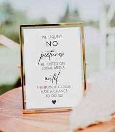 a sign that says we request no pictures be posted on social media until the bride and groom have a chance to do so