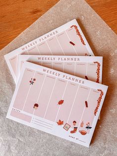 three weekly planner cards sitting on top of each other