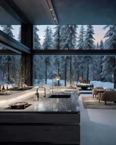 a large kitchen with an island counter and chairs in front of a window that looks out onto the woods