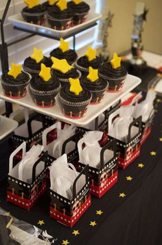 some cupcakes are sitting on top of trays that have stars on them