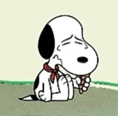 a cartoon dog is sitting on the ground with his head in his hands and eyes closed